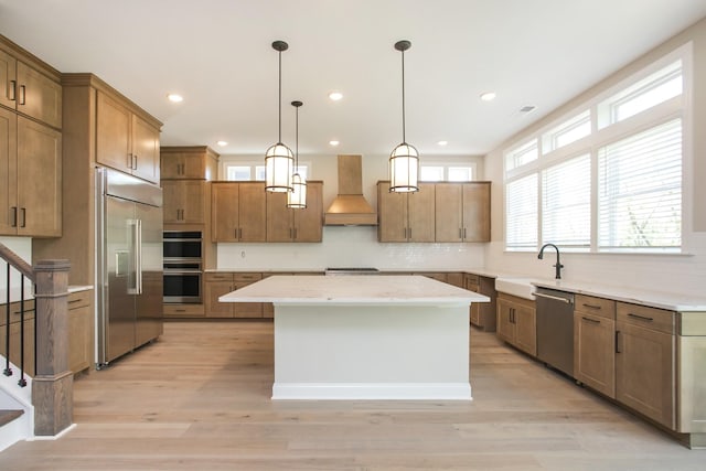 5956 Hunt Valley Dr, Spring Hill, TN 37174 - kitchen featuring premium range hood, stainless steel appliances, a sink, a center island, and decorative backsplash
