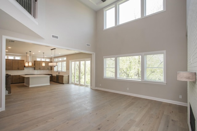 5956 Hunt Valley Dr, Spring Hill, TN 37174 - unfurnished living room with a high ceiling, light wood-type flooring, plenty of natural light, and recessed lighting