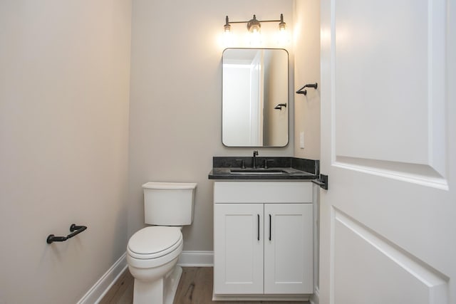 5956 Hunt Valley Dr, Spring Hill, TN 37174 - bathroom featuring vanity, toilet, baseboards, and wood finished floors