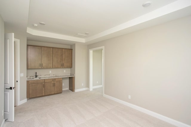 5956 Hunt Valley Dr, Spring Hill, TN 37174 - kitchen with light countertops, baseboards, light colored carpet, and brown cabinets