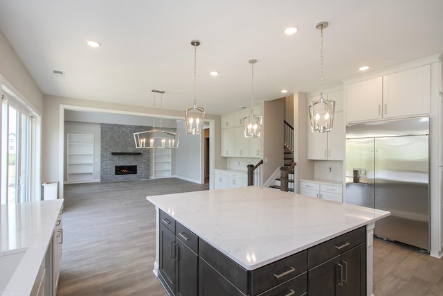 5952 Hunt Valley Dr, Spring Hill, TN 37174 - kitchen featuring built in refrigerator, a chandelier, white cabinets, and recessed lighting