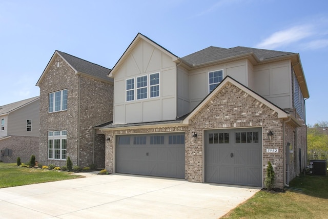 5952 Hunt Valley Dr, Spring Hill, TN 37174 - view of front facade with concrete driveway, central AC, brick siding, and an attached garage