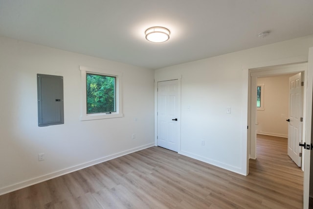 1320 Napier Lake Rd, Hohenwald, TN 38462 - unfurnished bedroom featuring electric panel, light wood finished floors, and baseboards