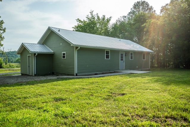 1320 Napier Lake Rd, Hohenwald, TN 38462 - back of property with metal roof, a lawn, and a patio area
