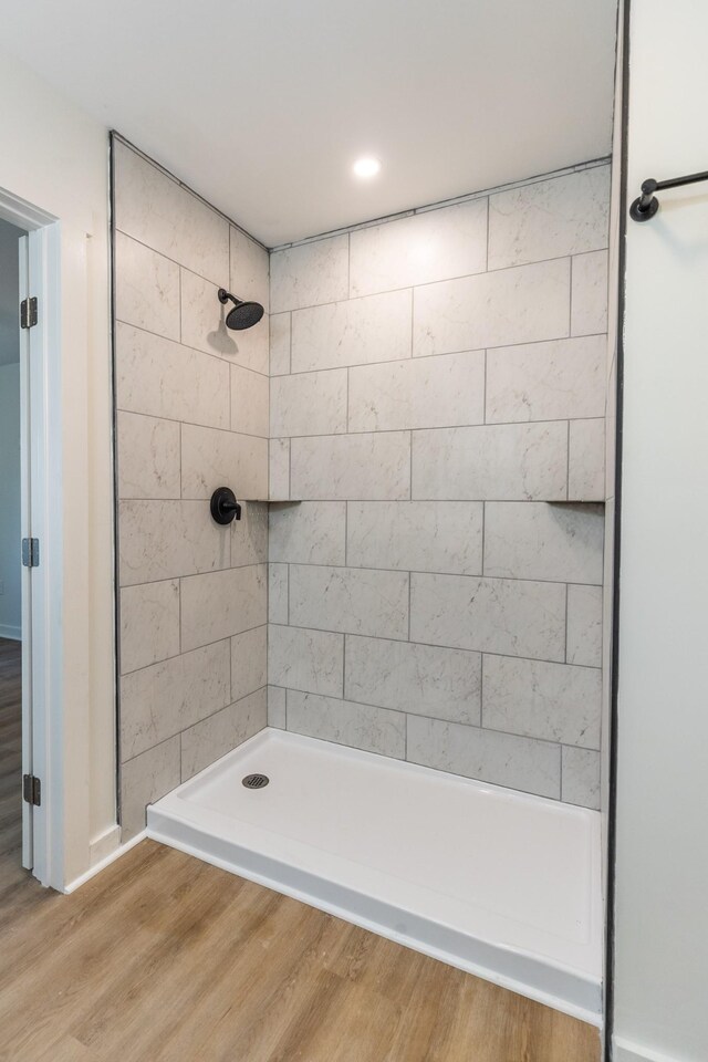 1320 Napier Lake Rd, Hohenwald, TN 38462 - full bathroom featuring a tile shower and wood finished floors