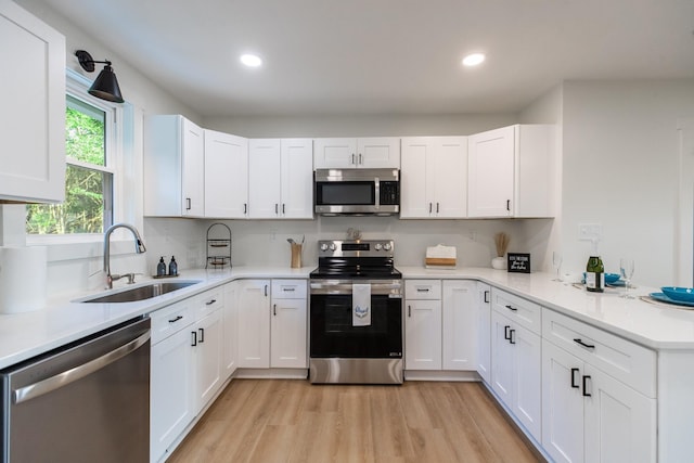 1320 Napier Lake Rd, Hohenwald, TN 38462 - kitchen featuring appliances with stainless steel finishes, a sink, light countertops, white cabinets, and recessed lighting