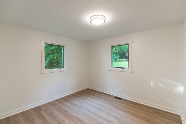 1320 Napier Lake Rd, Hohenwald, TN 38462 - empty room with healthy amount of natural light, light wood-style floors, and baseboards