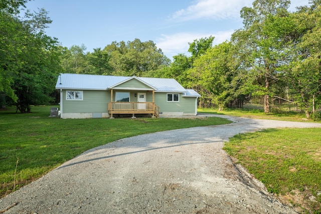 1320 Napier Lake Rd, Hohenwald, TN 38462 - view of front of home featuring driveway, a front yard, and metal roof