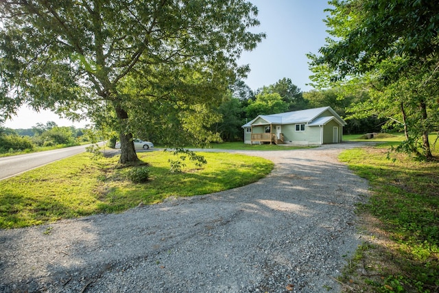 1320 Napier Lake Rd, Hohenwald, TN 38462 - view of front of house featuring driveway, a front yard, and an attached garage