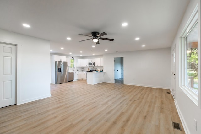 1320 Napier Lake Rd, Hohenwald, TN 38462 - unfurnished living room featuring recessed lighting, baseboards, ceiling fan, light wood-style flooring, and a sink