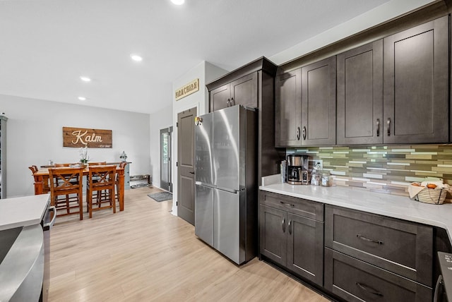 1415 Southside Rd, Southside, TN 37171 - kitchen with freestanding refrigerator, backsplash, light wood-type flooring, recessed lighting, and dark brown cabinets
