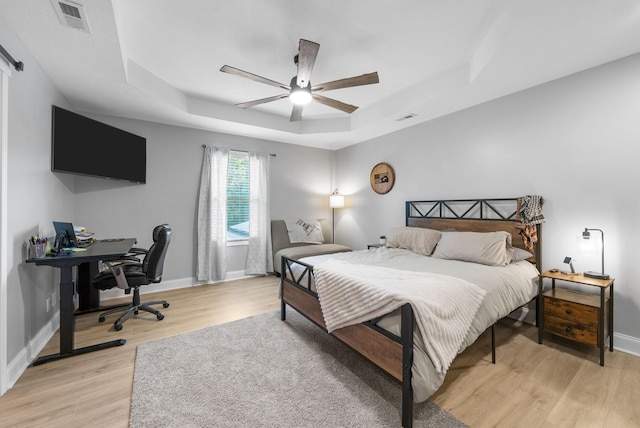 1415 Southside Rd, Southside, TN 37171 - bedroom with a raised ceiling, light wood-type flooring, a desk, and ceiling fan