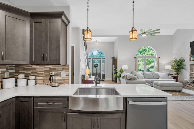 1415 Southside Rd, Southside, TN 37171 - kitchen featuring stainless steel dishwasher, open floor plan, dark brown cabinetry, and tasteful backsplash