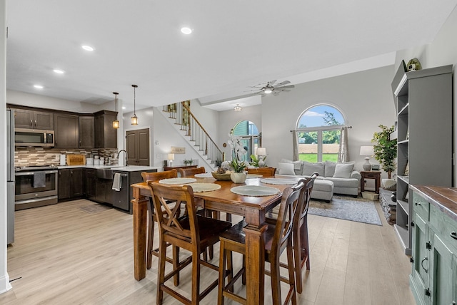 1415 Southside Rd, Southside, TN 37171 - dining room featuring light wood-style floors, stairs, ceiling fan, and recessed lighting
