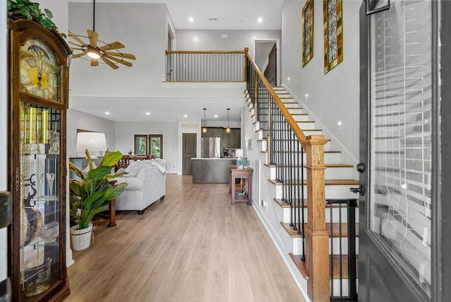 1415 Southside Rd, Southside, TN 37171 - entrance foyer with a ceiling fan, light wood finished floors, stairway, a towering ceiling, and recessed lighting