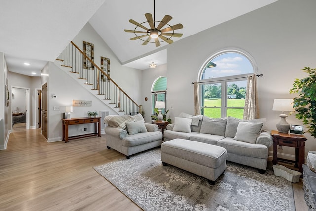1415 Southside Rd, Southside, TN 37171 - living room featuring stairway, light wood finished floors, ceiling fan, and high vaulted ceiling