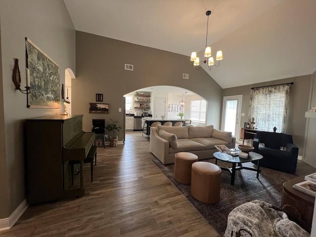 219 Dugger Dr, Clarksville, TN 37042 - living area featuring arched walkways, high vaulted ceiling, a chandelier, dark wood finished floors, and baseboards