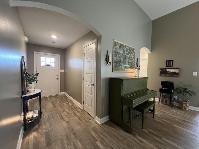219 Dugger Dr, Clarksville, TN 37042 - entrance foyer with arched walkways, dark wood-style floors, baseboards, and high vaulted ceiling