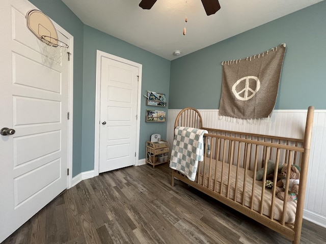 219 Dugger Dr, Clarksville, TN 37042 - bedroom featuring a nursery area, wood finished floors, a ceiling fan, and baseboards