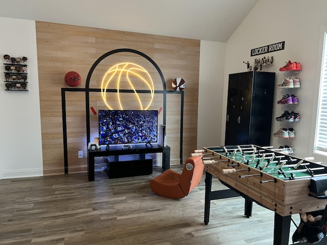 219 Dugger Dr, Clarksville, TN 37042 - recreation room featuring wood walls, wood finished floors, vaulted ceiling, baseboards, and an accent wall