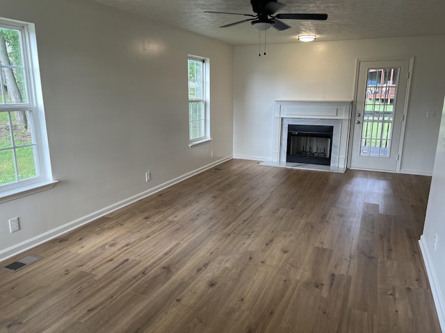 3048 Chateau Valley Dr, Nashville, TN 37207 - unfurnished living room with ceiling fan, a high end fireplace, wood finished floors, plenty of natural light, and a textured ceiling