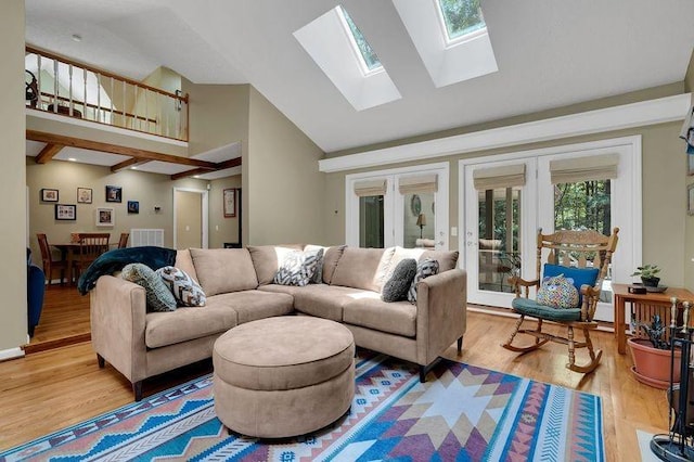 891 Deepwoods Rd, Sewanee, TN 37375 - living area with high vaulted ceiling, a skylight, light wood-style floors, and french doors
