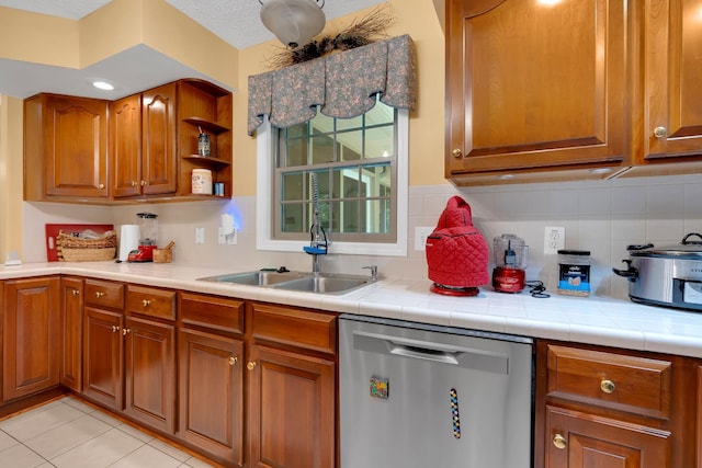 891 Deepwoods Rd, Sewanee, TN 37375 - kitchen featuring dishwasher, brown cabinets, a sink, tasteful backsplash, and light countertops