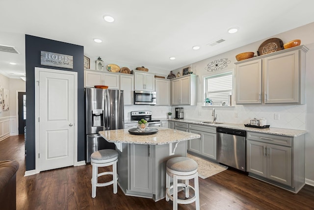 2932 Hen Brook Dr, Columbia, TN 38401 - kitchen featuring appliances with stainless steel finishes, a breakfast bar area, tasteful backsplash, a kitchen island, and recessed lighting