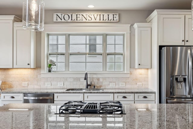9201 Dutch Belted Ct, Nolensville, TN 37135 - kitchen with appliances with stainless steel finishes, a sink, white cabinets, decorative backsplash, and light stone countertops