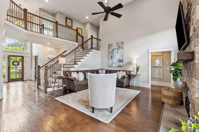 9201 Dutch Belted Ct, Nolensville, TN 37135 - living room featuring a towering ceiling, ceiling fan, stairs, dark wood-style flooring, and baseboards