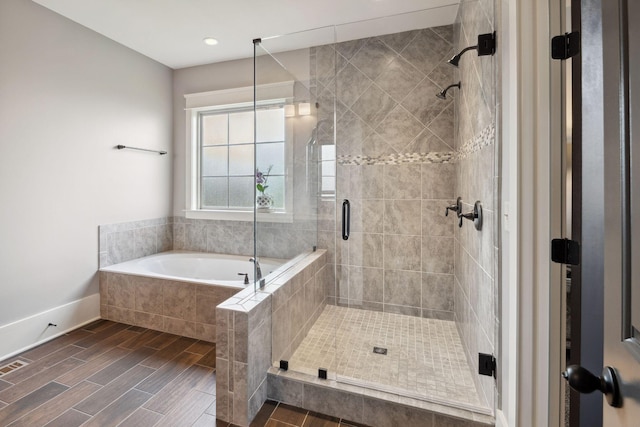 9201 Dutch Belted Ct, Nolensville, TN 37135 - bathroom featuring a stall shower, a garden tub, wood finished floors, baseboards, and recessed lighting