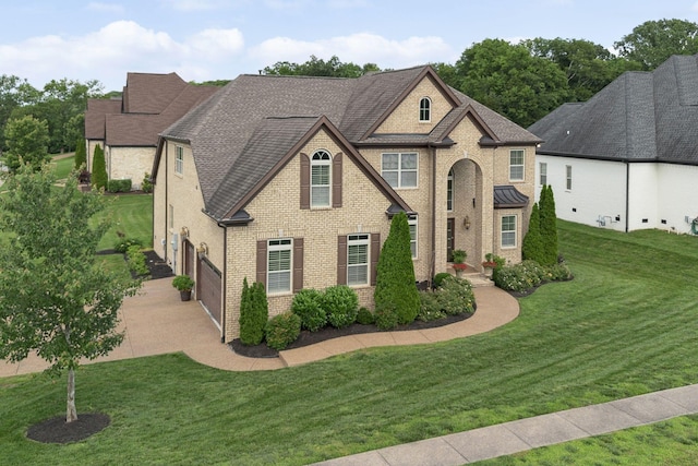 9201 Dutch Belted Ct, Nolensville, TN 37135 - view of front of house featuring concrete driveway, brick siding, an attached garage, and a front yard