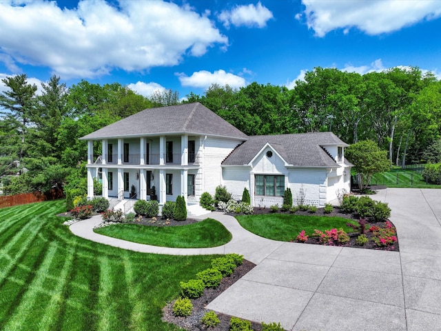 1004 Jones Pkwy, Brentwood, TN 37027 - greek revival inspired property featuring a porch, a balcony, roof with shingles, and concrete driveway