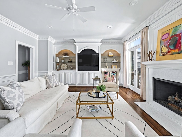 1004 Jones Pkwy, Brentwood, TN 37027 - living room featuring a fireplace, wood finished floors, a ceiling fan, ornamental molding, and recessed lighting