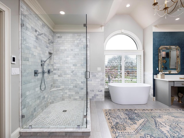 1004 Jones Pkwy, Brentwood, TN 37027 - bathroom featuring a stall shower, a freestanding bath, vanity, a chandelier, and crown molding