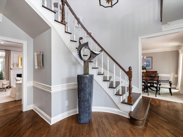 1004 Jones Pkwy, Brentwood, TN 37027 - staircase with wood finished floors, baseboards, a chandelier, and crown molding