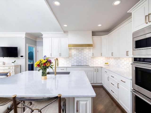 1004 Jones Pkwy, Brentwood, TN 37027 - kitchen with a sink, wall chimney exhaust hood, appliances with stainless steel finishes, crown molding, and white cabinets