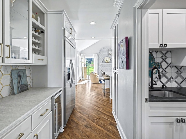 1004 Jones Pkwy, Brentwood, TN 37027 - bar with wine cooler, stainless steel built in refrigerator, a sink, dark wood-type flooring, and decorative backsplash