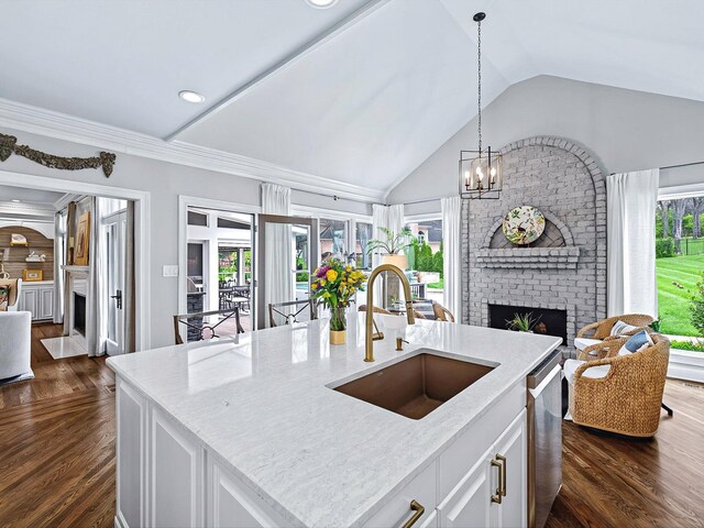1004 Jones Pkwy, Brentwood, TN 37027 - kitchen featuring a brick fireplace, a sink, open floor plan, dishwasher, and vaulted ceiling