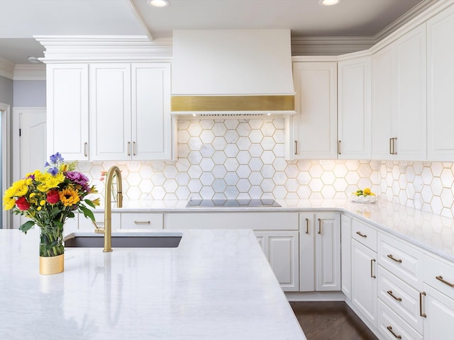 1004 Jones Pkwy, Brentwood, TN 37027 - kitchen featuring wall chimney exhaust hood, black electric stovetop, recessed lighting, white cabinetry, and a sink