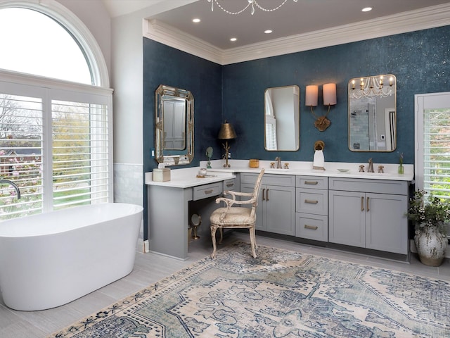 1004 Jones Pkwy, Brentwood, TN 37027 - bathroom with a freestanding bath, plenty of natural light, double vanity, a chandelier, and ornamental molding
