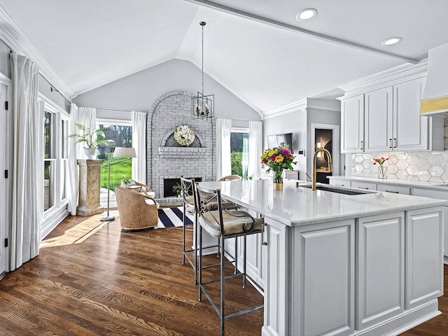 1004 Jones Pkwy, Brentwood, TN 37027 - kitchen featuring a sink, plenty of natural light, a fireplace, white cabinetry, and vaulted ceiling
