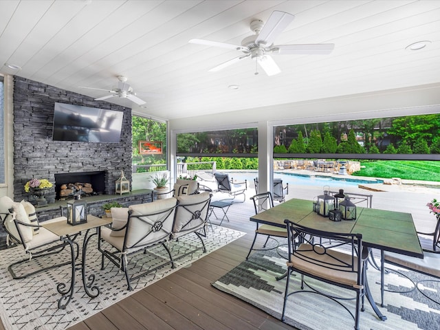 1004 Jones Pkwy, Brentwood, TN 37027 - wooden terrace with a stone fireplace, ceiling fan, outdoor dining space, and an outdoor pool