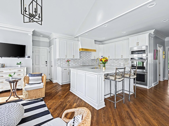 1004 Jones Pkwy, Brentwood, TN 37027 - kitchen with custom exhaust hood, stainless steel appliances, white cabinetry, light countertops, and crown molding