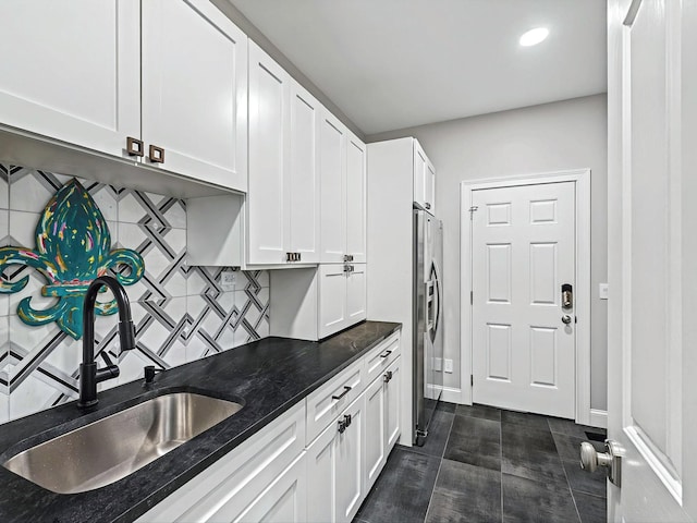 1004 Jones Pkwy, Brentwood, TN 37027 - kitchen with a sink, stainless steel fridge with ice dispenser, tasteful backsplash, white cabinets, and dark stone countertops