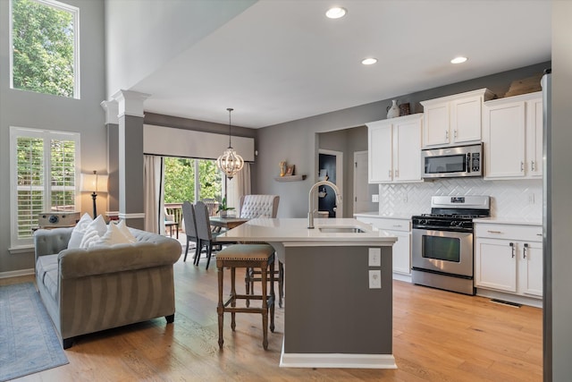 736 Arbor Springs Dr, Mount Juliet, TN 37122 - kitchen featuring appliances with stainless steel finishes, a sink, white cabinets, decorative backsplash, and light countertops