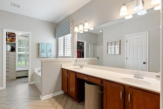 736 Arbor Springs Dr, Mount Juliet, TN 37122 - bathroom with double vanity, a bath, a walk in closet, a stall shower, and baseboards