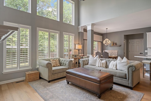 736 Arbor Springs Dr, Mount Juliet, TN 37122 - living area with a chandelier, light wood finished floors, a high ceiling, and baseboards