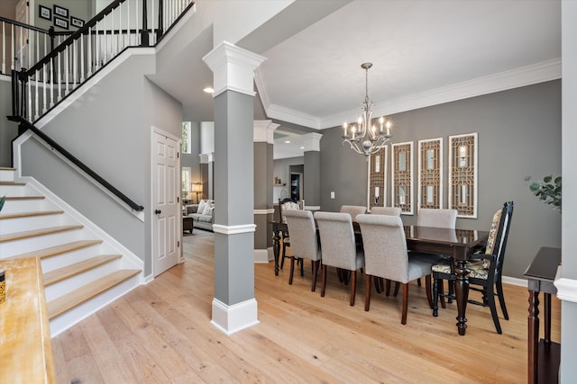 736 Arbor Springs Dr, Mount Juliet, TN 37122 - dining space with stairway, decorative columns, light wood-type flooring, a chandelier, and crown molding