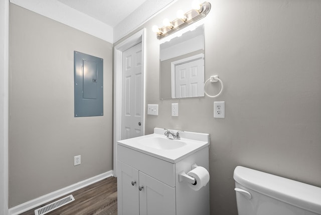 123 Koffman Dr, Hopkinsville, KY 42240 - bathroom with electric panel, toilet, vanity, wood finished floors, and baseboards